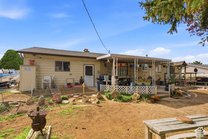 Exterior with covered patio, concrete patio surface, and a separate storage shed