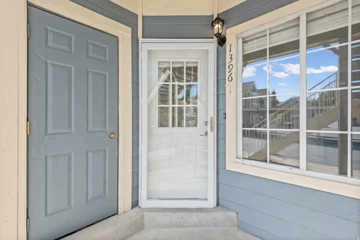Exterior entrance featuring a paneled door and a glass view screen door.