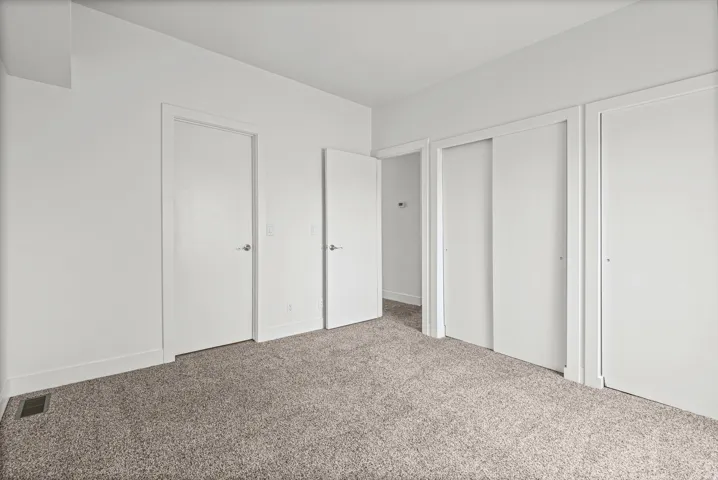 Alternative view of the primary bedroom with direct bathroom access.