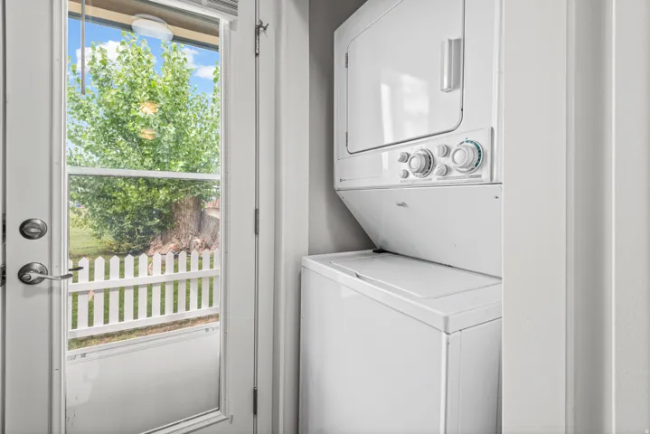 Stackable washer and dryer unit included.
