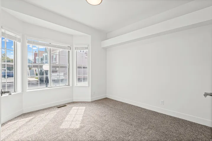 Second bedroom featuring bay windows.