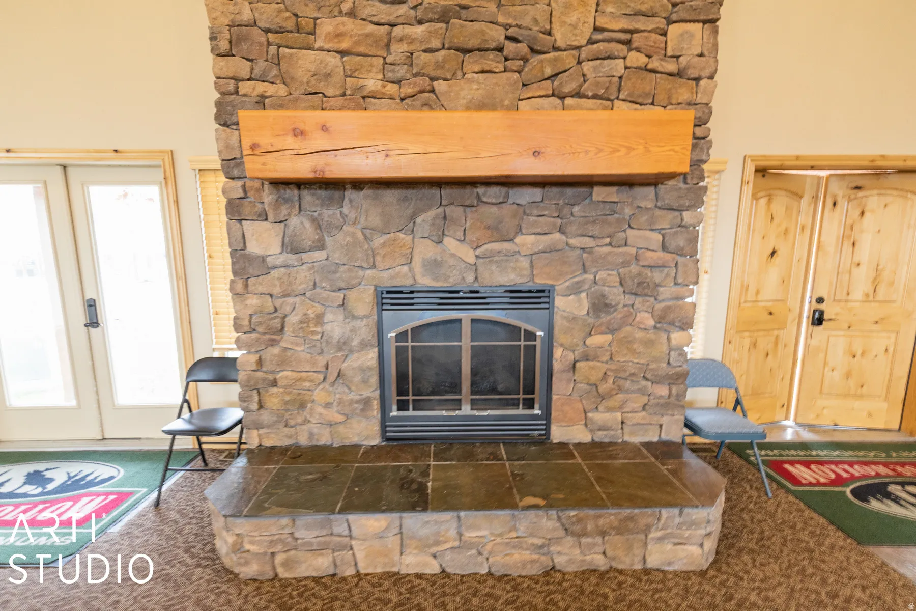 Stone-clad fireplace with a wood mantel and tiled hearth