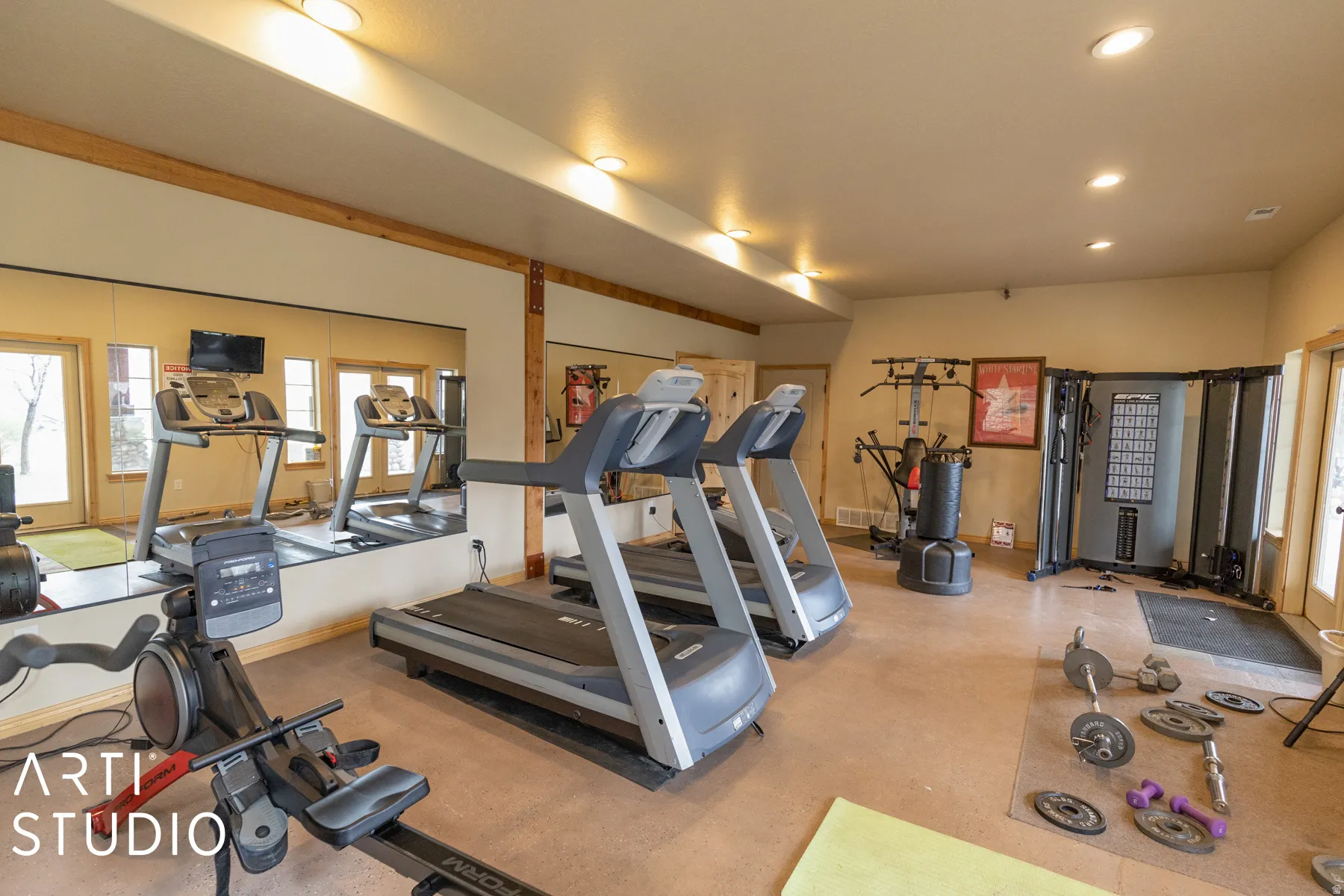 Recessed lighting, wood-beam accents, full-wall mirrors, and a neutral wall color