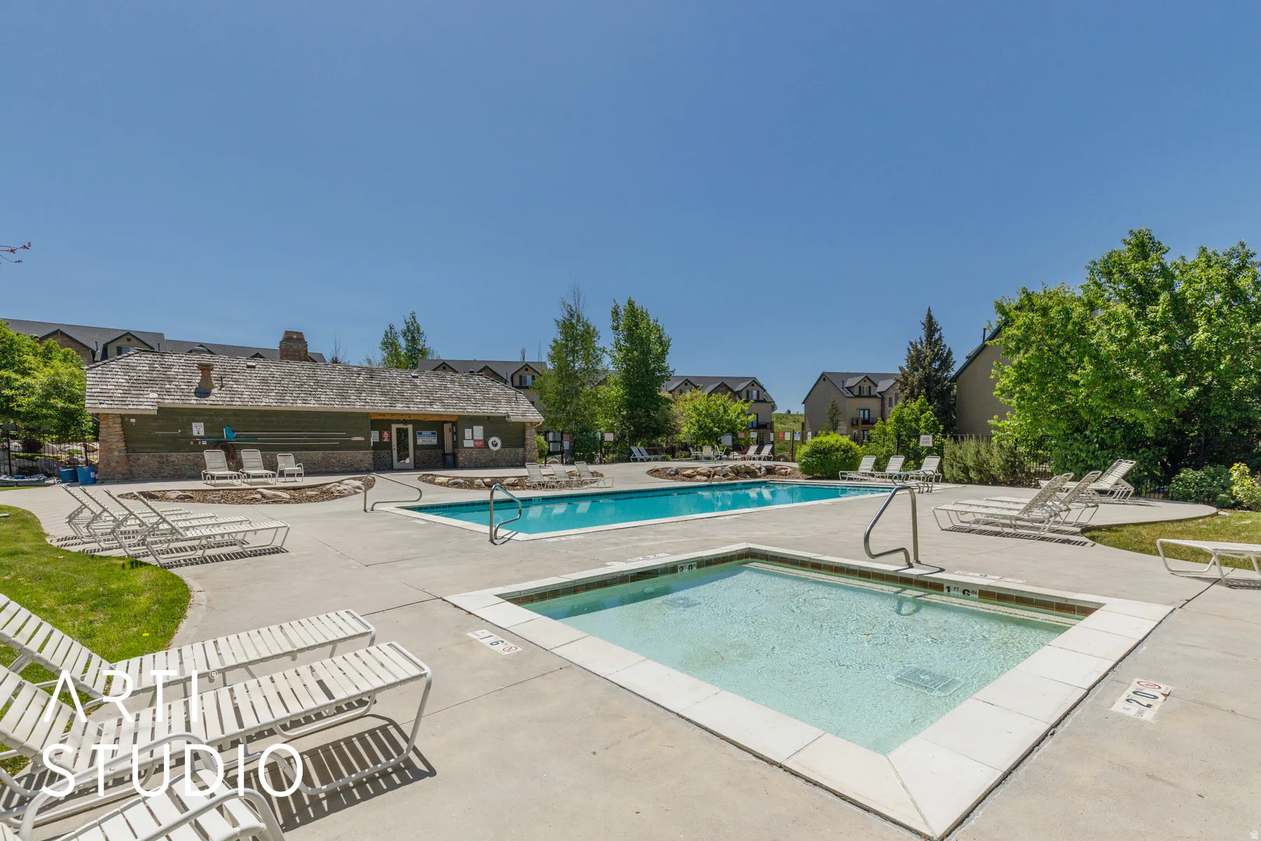 Outdoor pool and spa with concrete surround