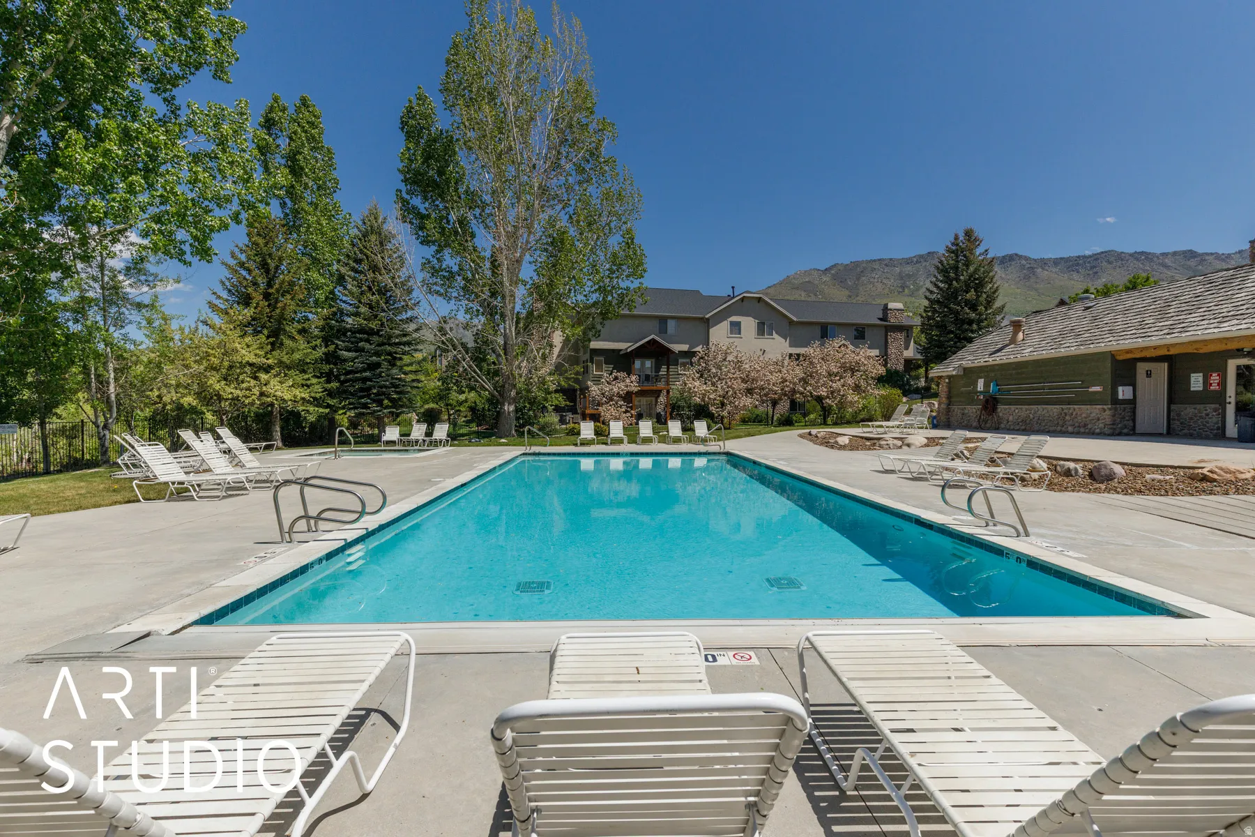 Outdoor swimming pool with integrated steps, surrounded by a concrete deck