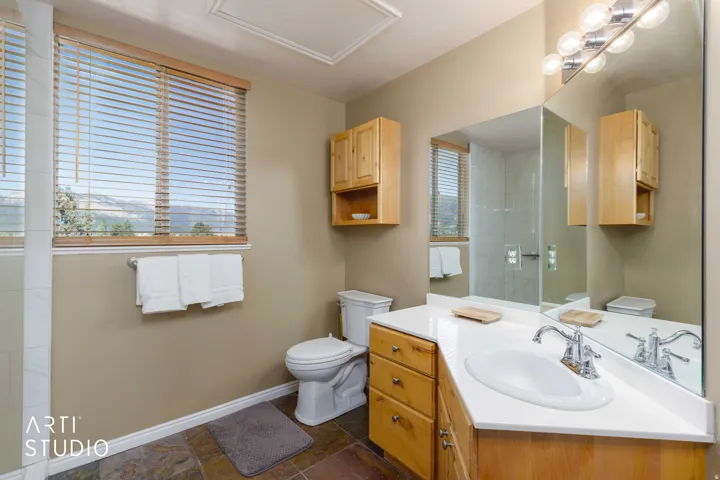 Wood-finish cabinetry and vanity with an integrated sink and chrome faucet