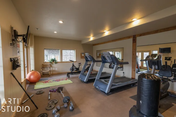 Dedicated fitness room featuring recessed lighting, a durable flooring surface, and multiple windows providing natural illumination