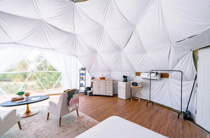Geodesic dome interior with wood-finish flooring