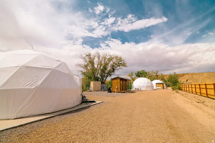 Multiple geodesic dome structures on a gravel lot