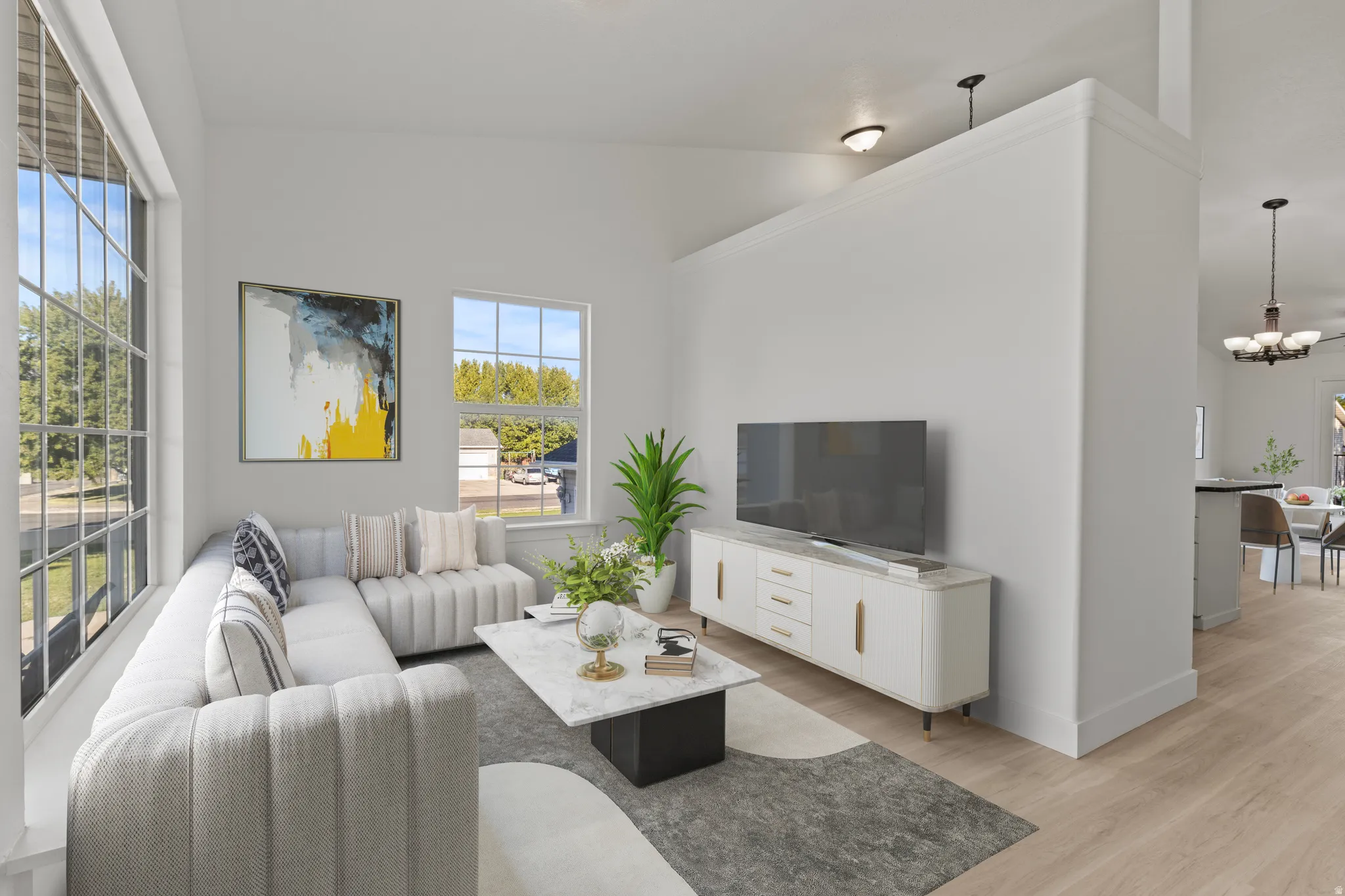 Vaulted ceilings, large picture windows, wood-finish flooring, recessed lighting, and an open concept layout