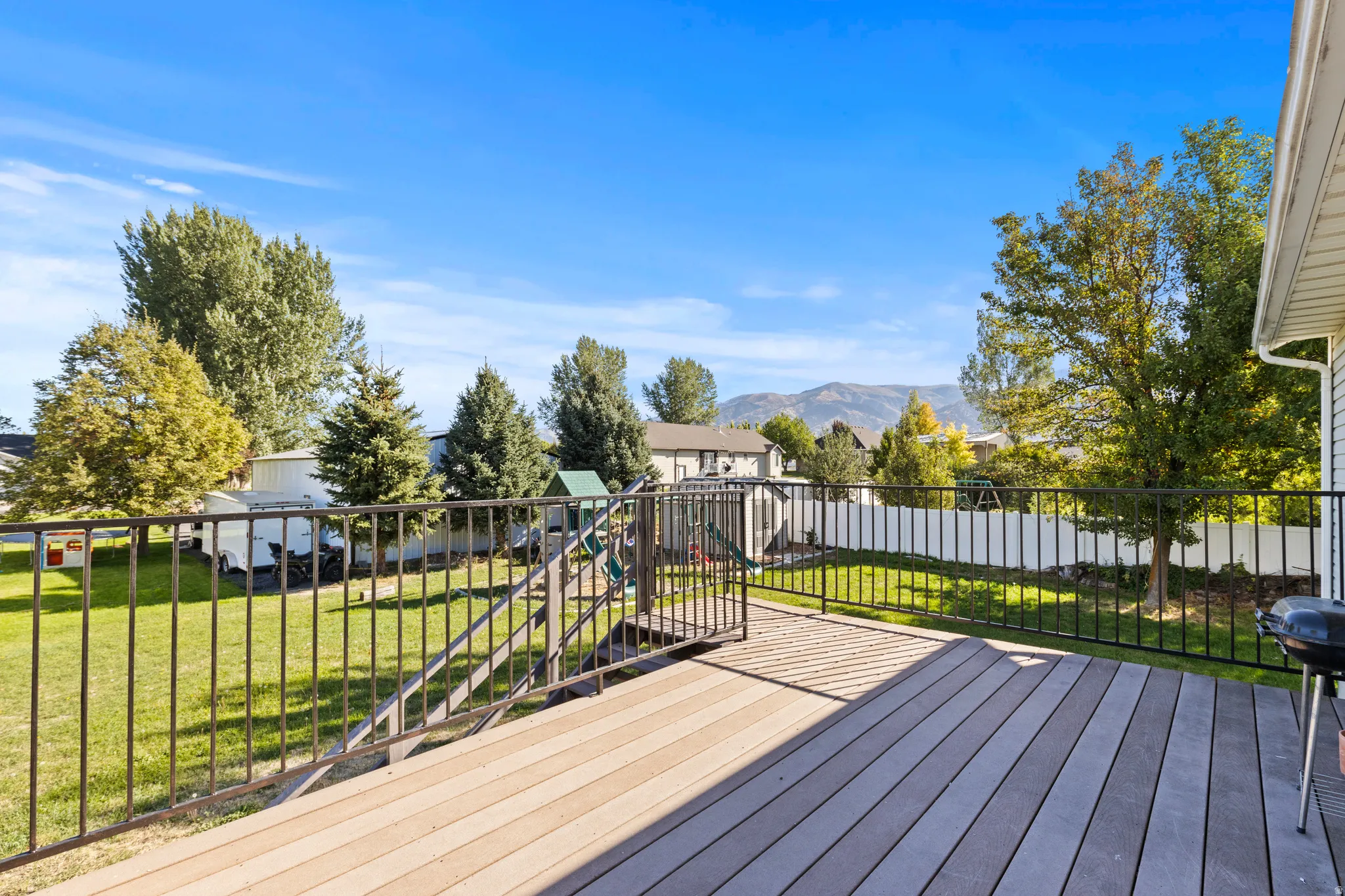 Expansive deck featuring composite decking and black metal railings