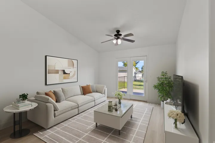 Vaulted ceiling with a ceiling fan, wood-finish flooring, and white walls