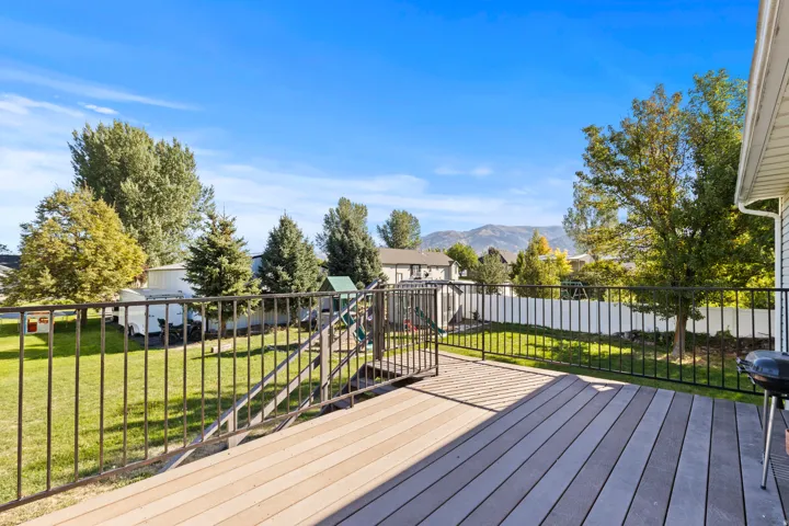 Expansive deck featuring composite decking and black metal railings