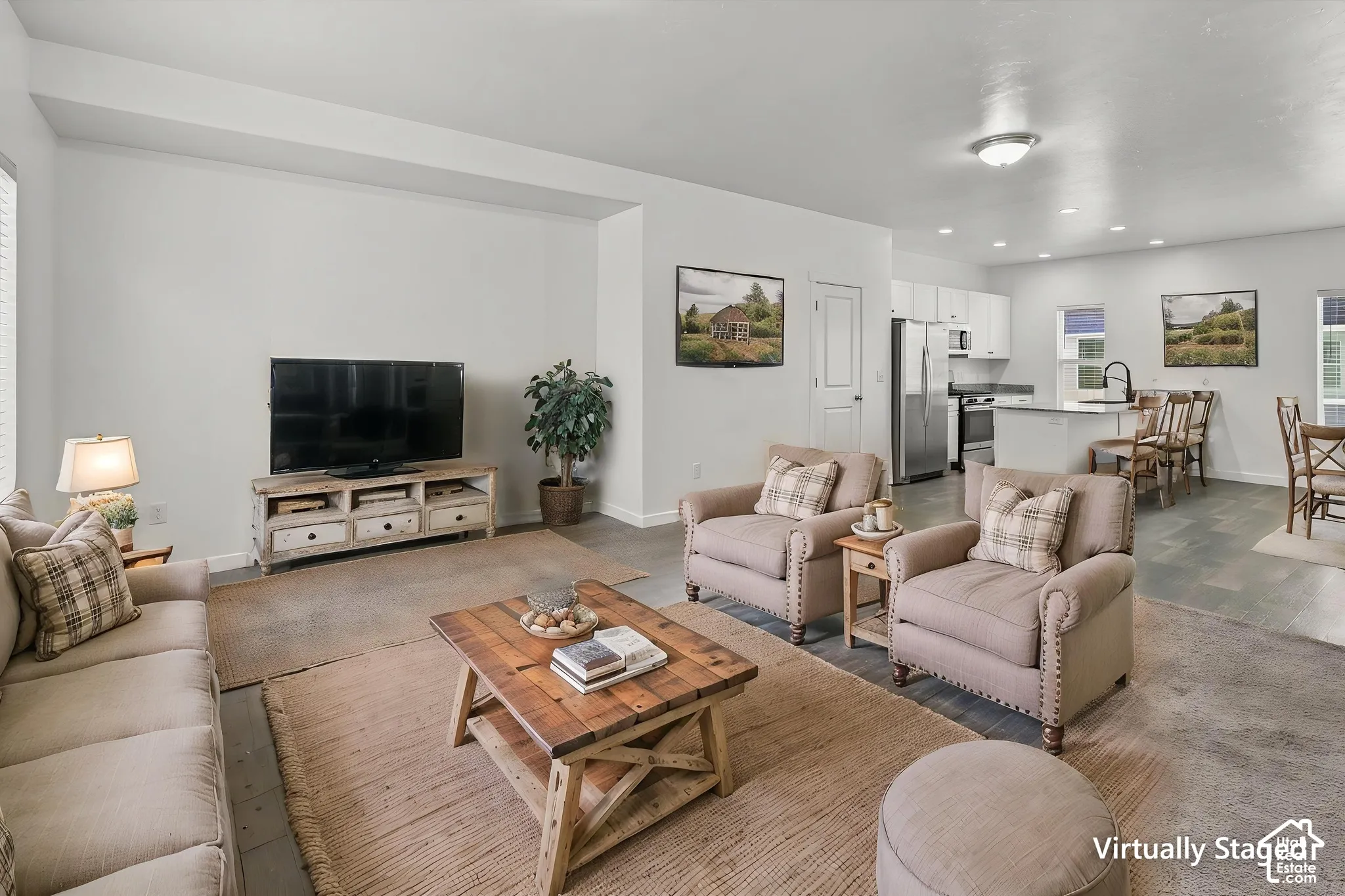 Open-concept interior featuring wood-finish flooring, recessed lighting, and a kitchen island with stone-finish countertops