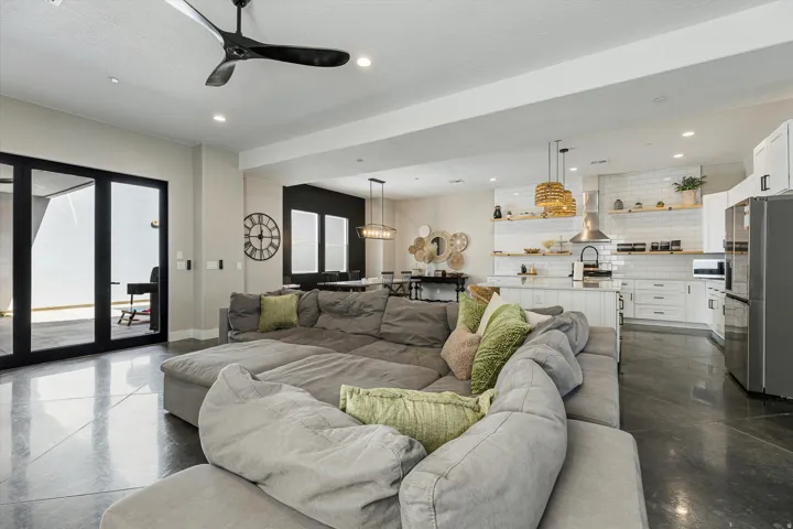 Polished concrete flooring, recessed lighting, and a modern ceiling fan