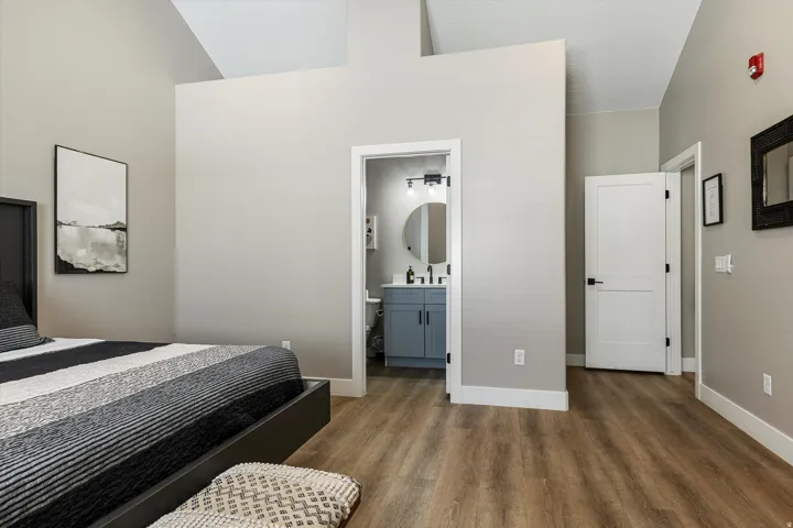 Wood-finish flooring throughout, vaulted ceiling, and recessed lighting