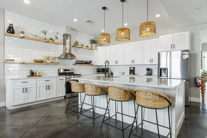 White subway tile backsplash with open wood shelving