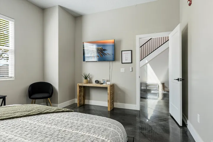 Polished concrete flooring, white trim, and a window with blinds