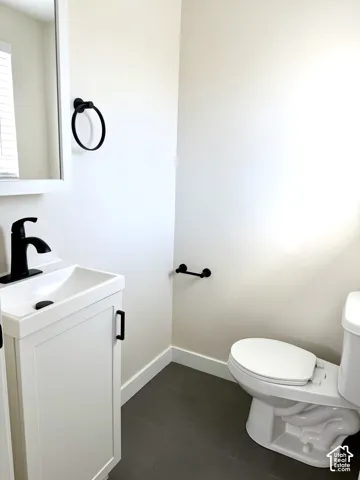 White vanity with integrated sink, matte black faucet, and coordinating hardware