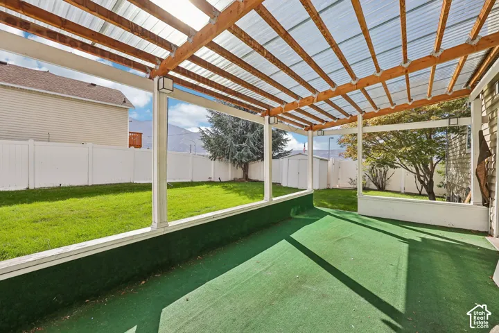 Covered patio with a clear panel roof and wood beam structure
