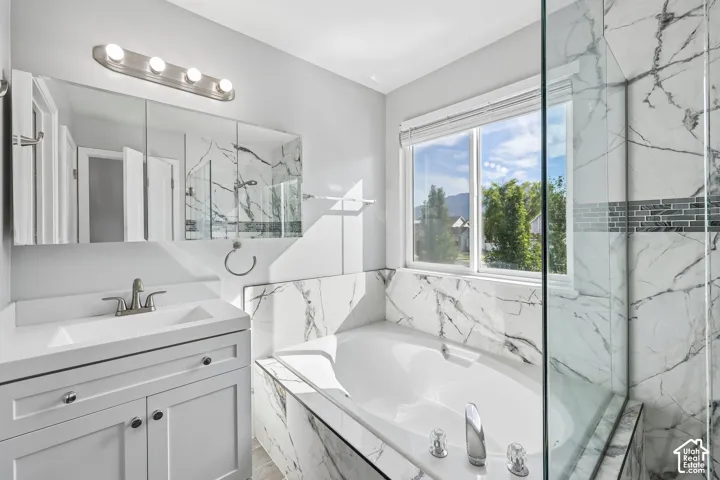 White vanity with integrated sink and brushed nickel fixtures