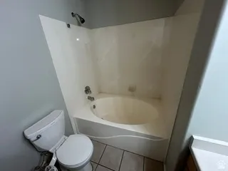 Integrated shower and tub combination with tile flooring