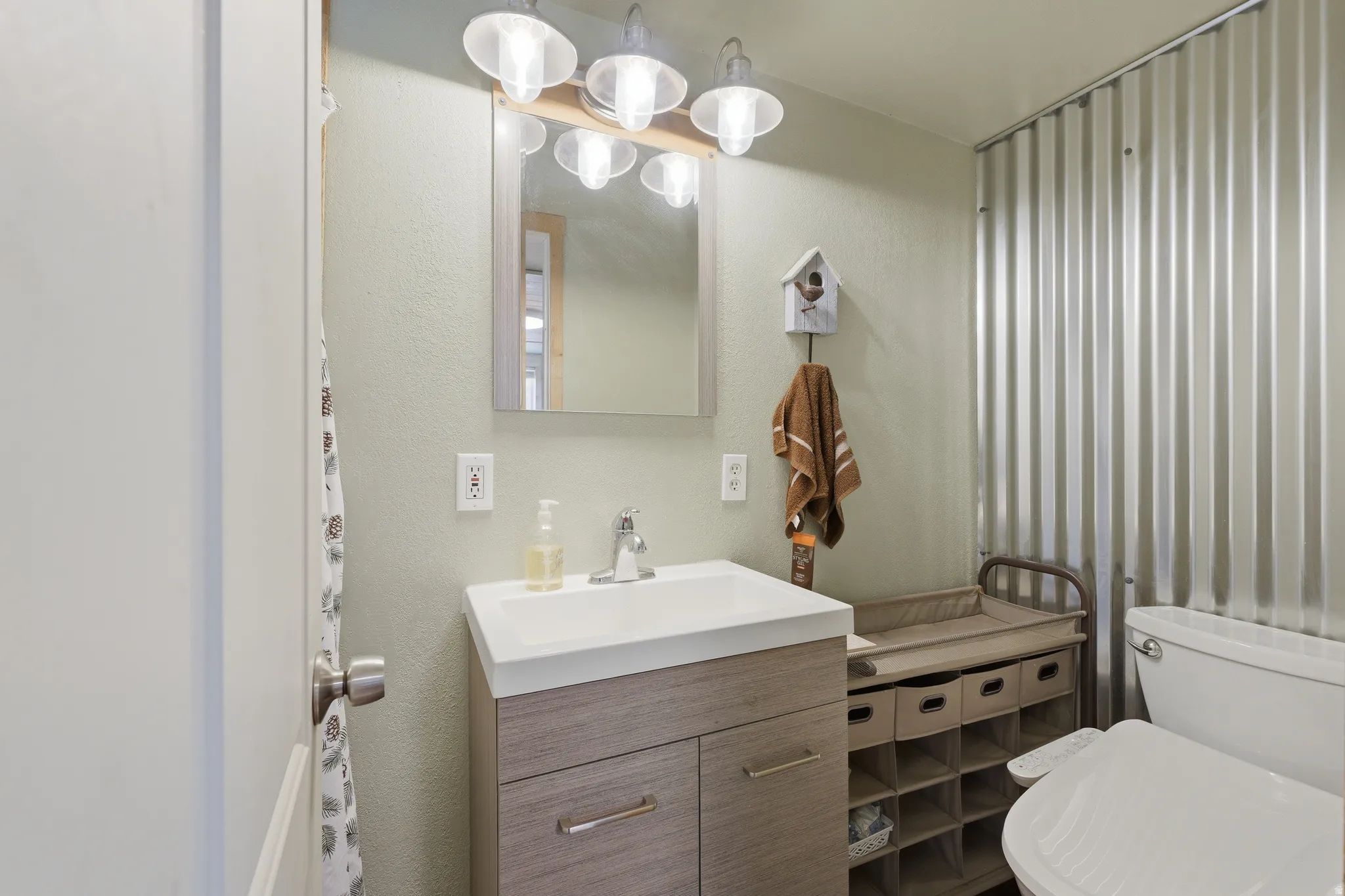 Wood-finish vanity with an integrated sink and chrome faucet