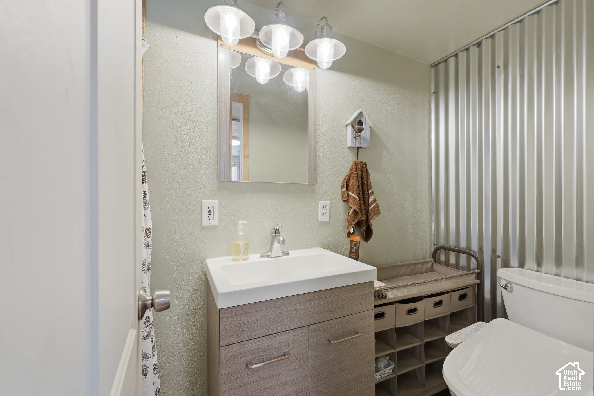 Wood-finish vanity with an integrated sink and chrome faucet