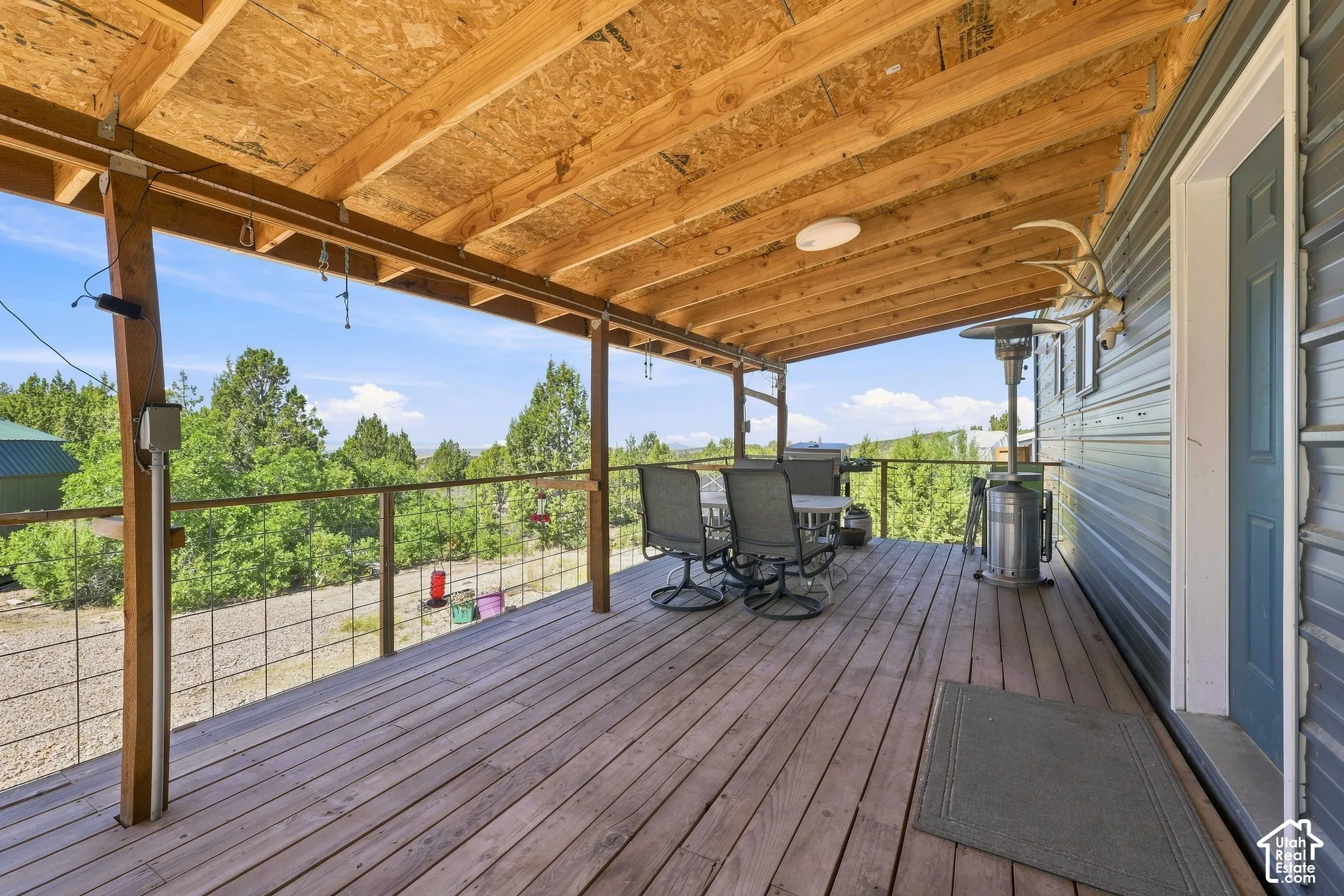 Covered wood-finish deck with open railing and exposed wood ceiling