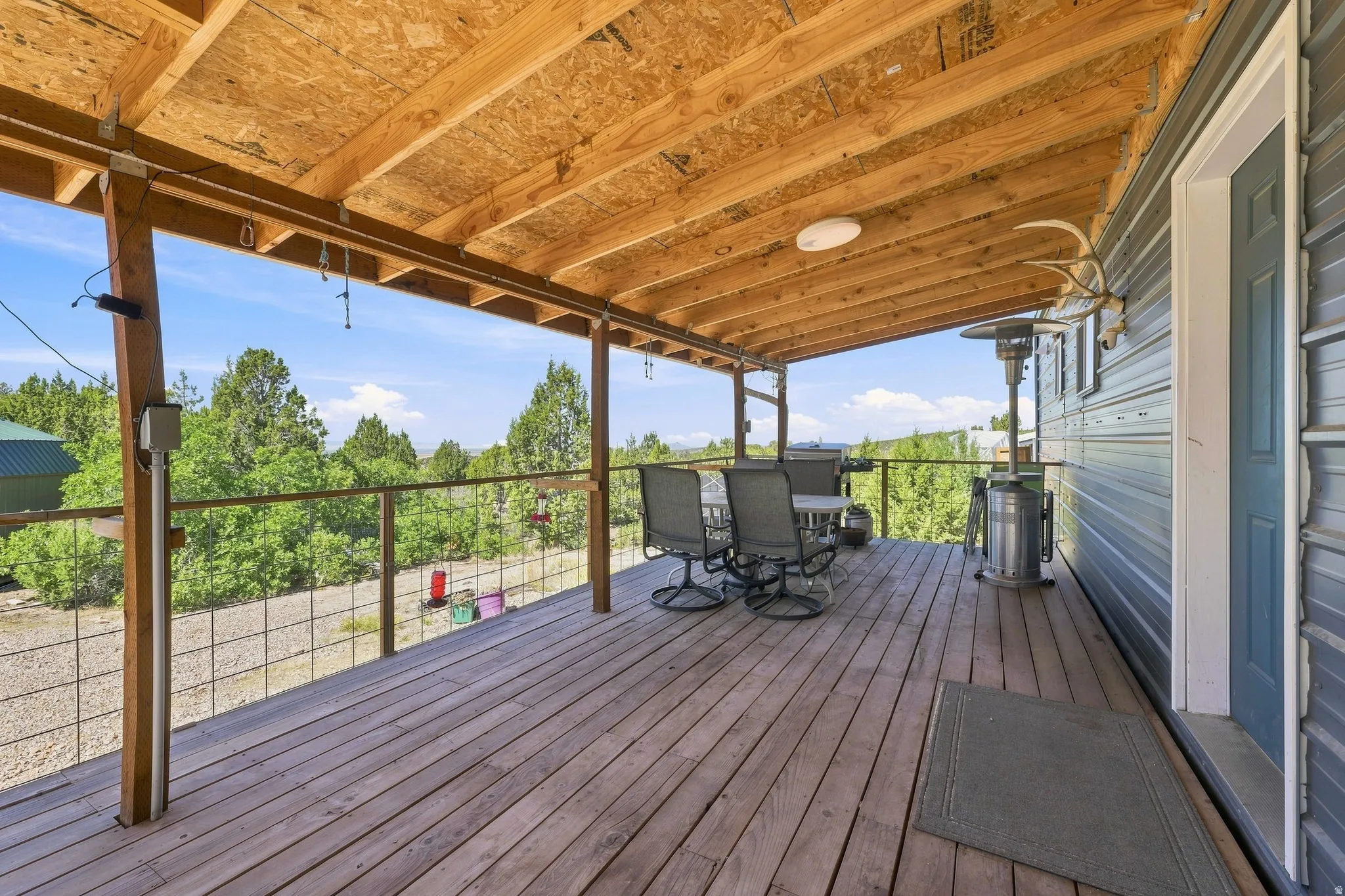 Covered wood-finish deck with open railing and exposed wood ceiling