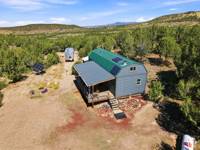 Barn-style structure with a green metal roof and solar panels