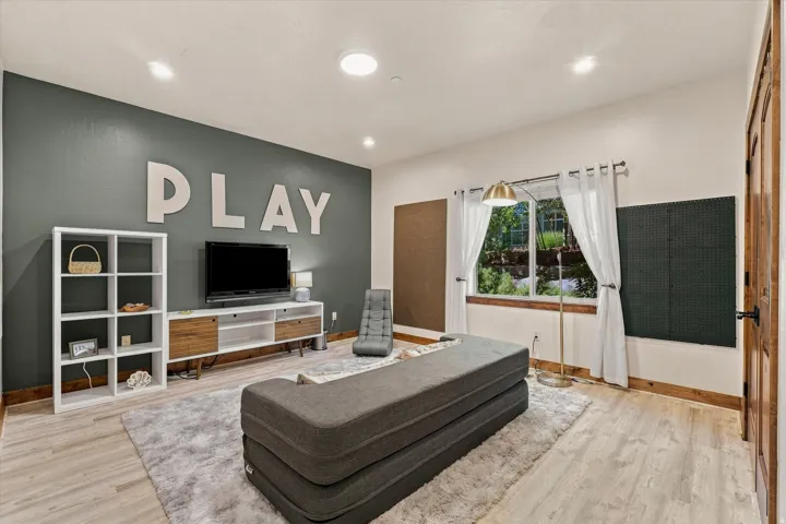 Wood-finish flooring, recessed lighting, and a window with exterior views
