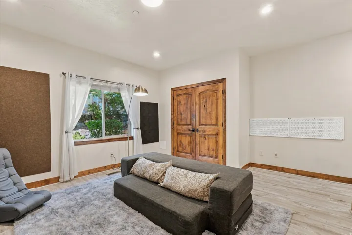 Recessed lighting, wood-finish flooring, and a window with a wood sill
