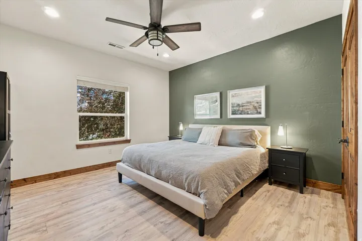Recessed lighting, wood-finish flooring, and a ceiling fan with light fixture