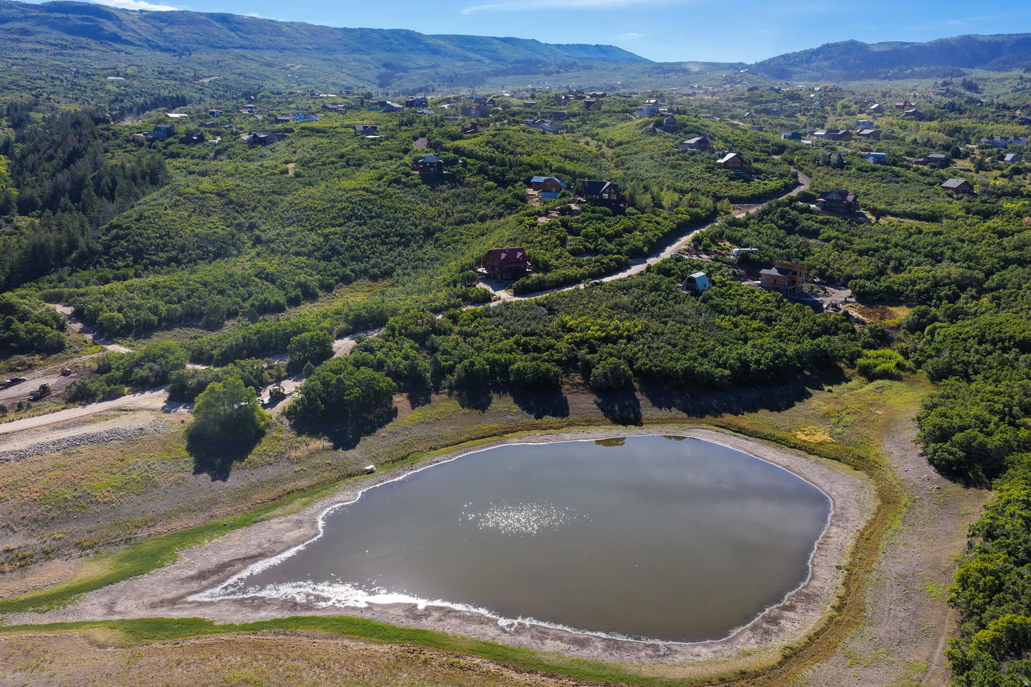 Expansive natural landscape with a prominent lake and surrounding hills