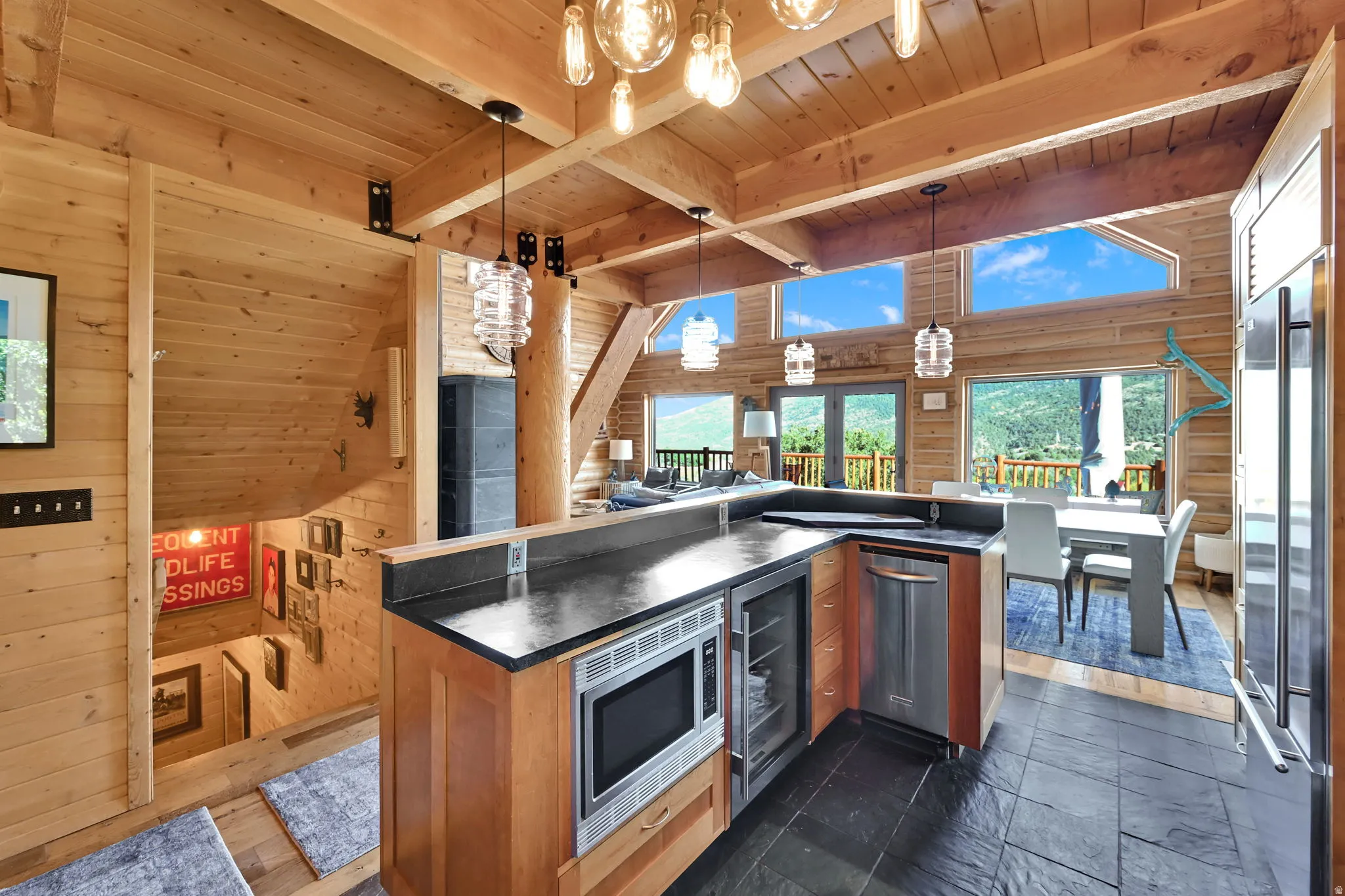Kitchen island featuring a built-in microwave, beverage cooler, and dishwasher