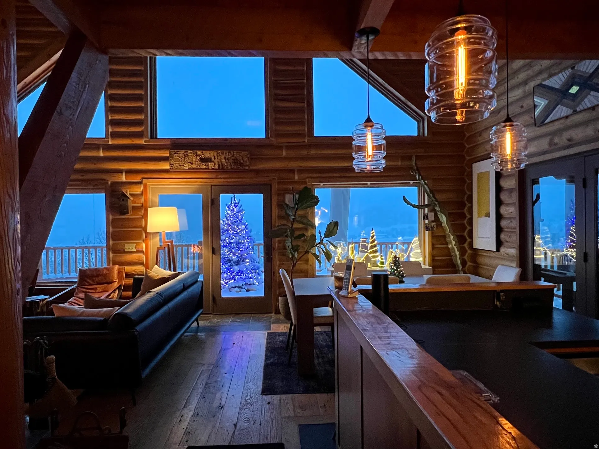 Wood-finish flooring, exposed wood beam ceiling, floor-to-ceiling windows, and recessed lighting