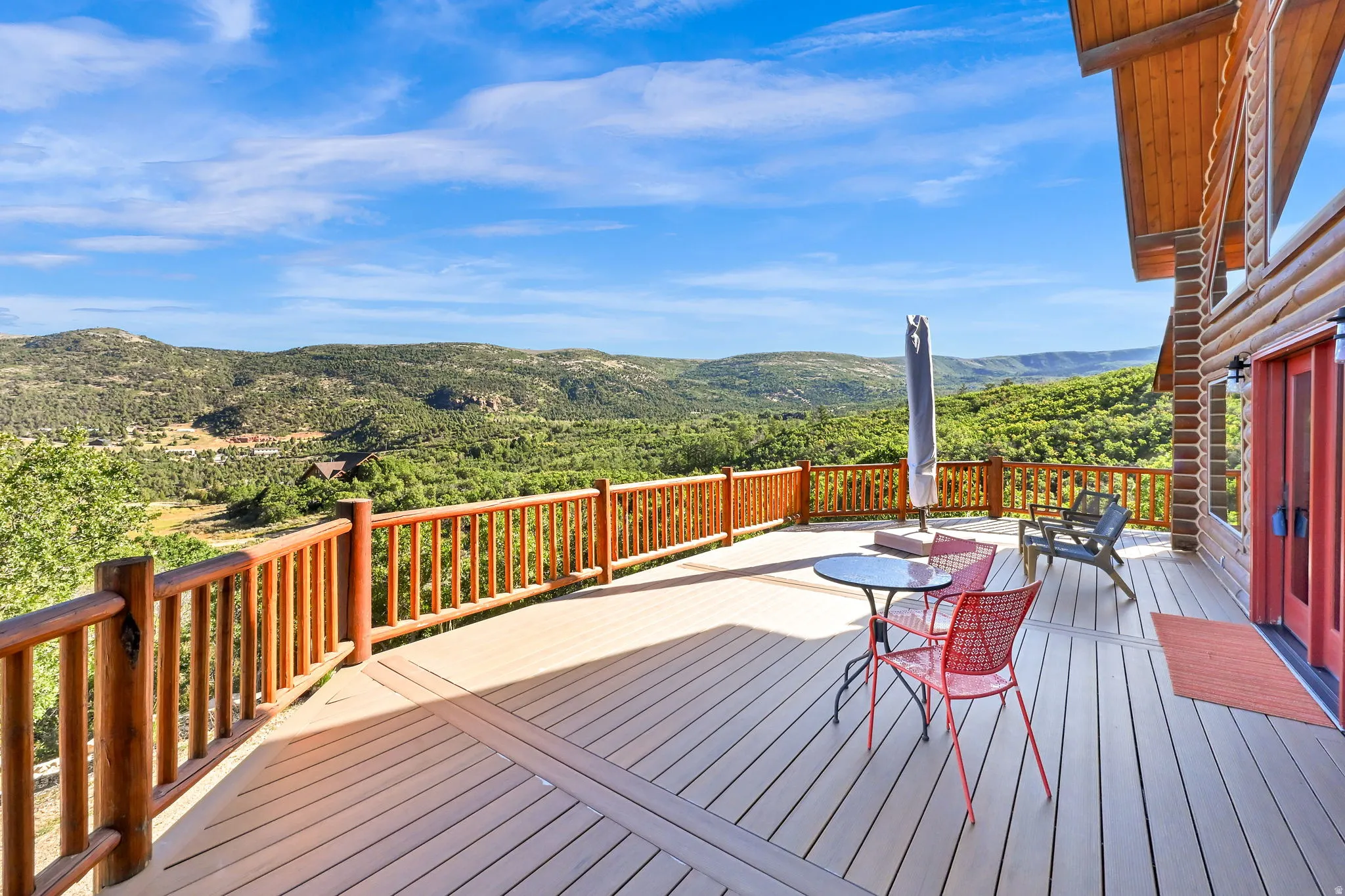 Expansive outdoor deck featuring composite decking and natural wood railings
