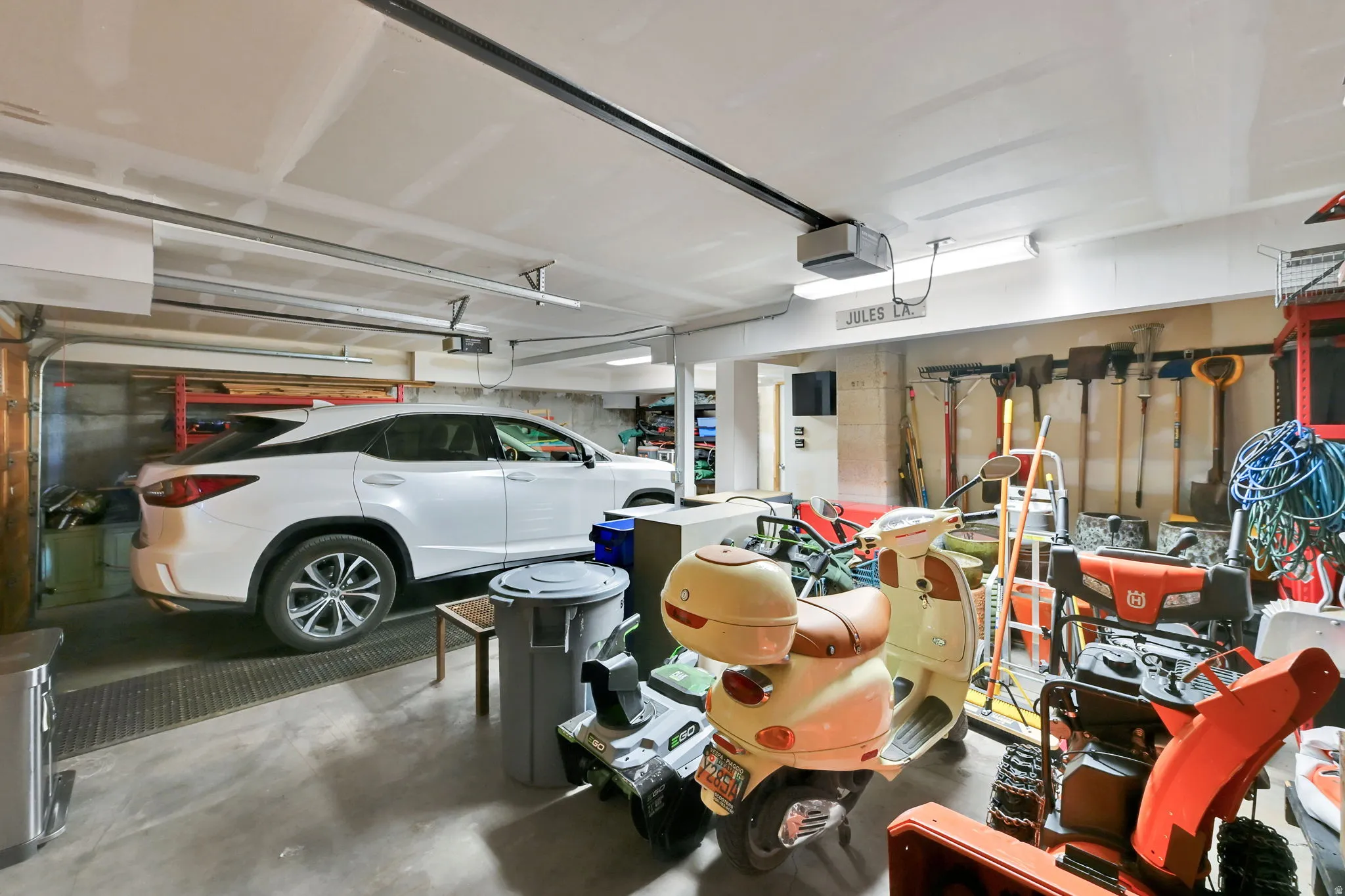 Concrete flooring with overhead lighting and a garage door track system
