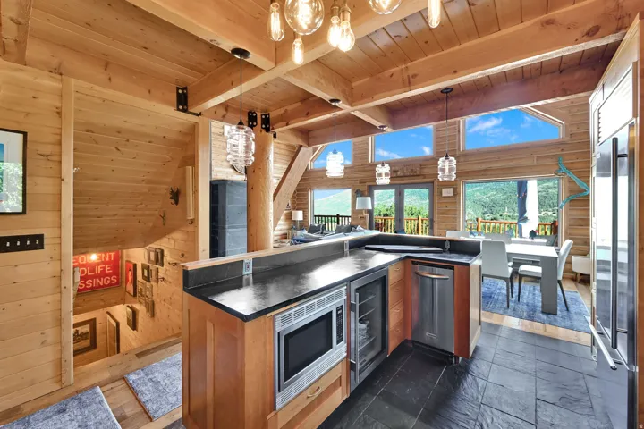 Kitchen island featuring a built-in microwave, beverage cooler, and dishwasher
