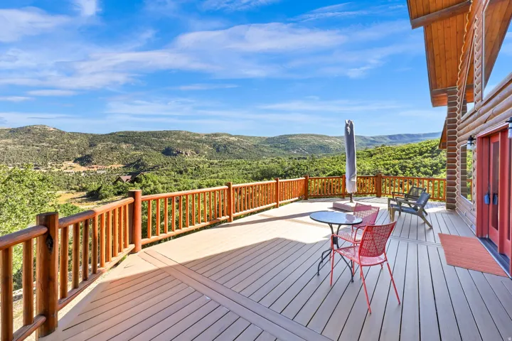 Expansive outdoor deck featuring composite decking and natural wood railings