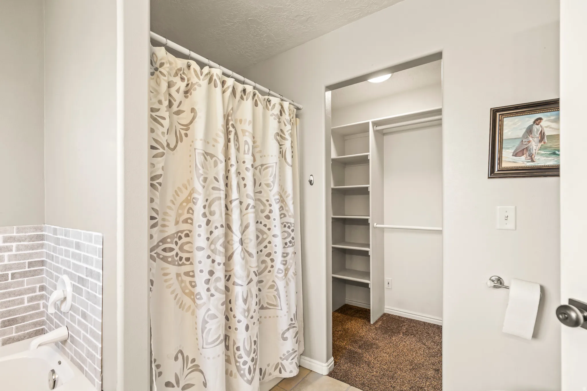 Recessed closet with built-in shelving and hanging rod