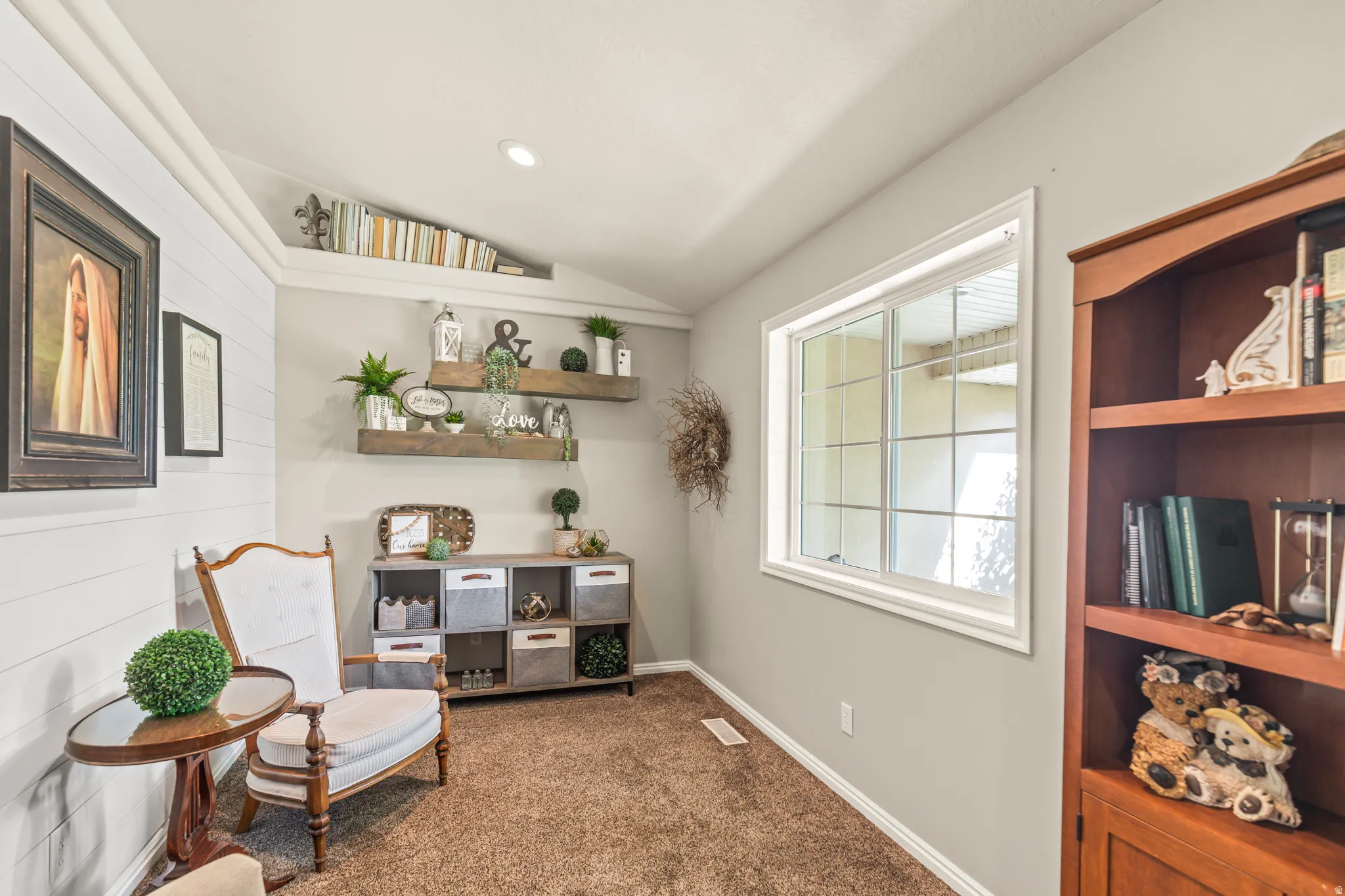 Accent wall with horizontal paneling, built-in shelving, recessed lighting, window with grid pattern, and a built-in wood bookcase