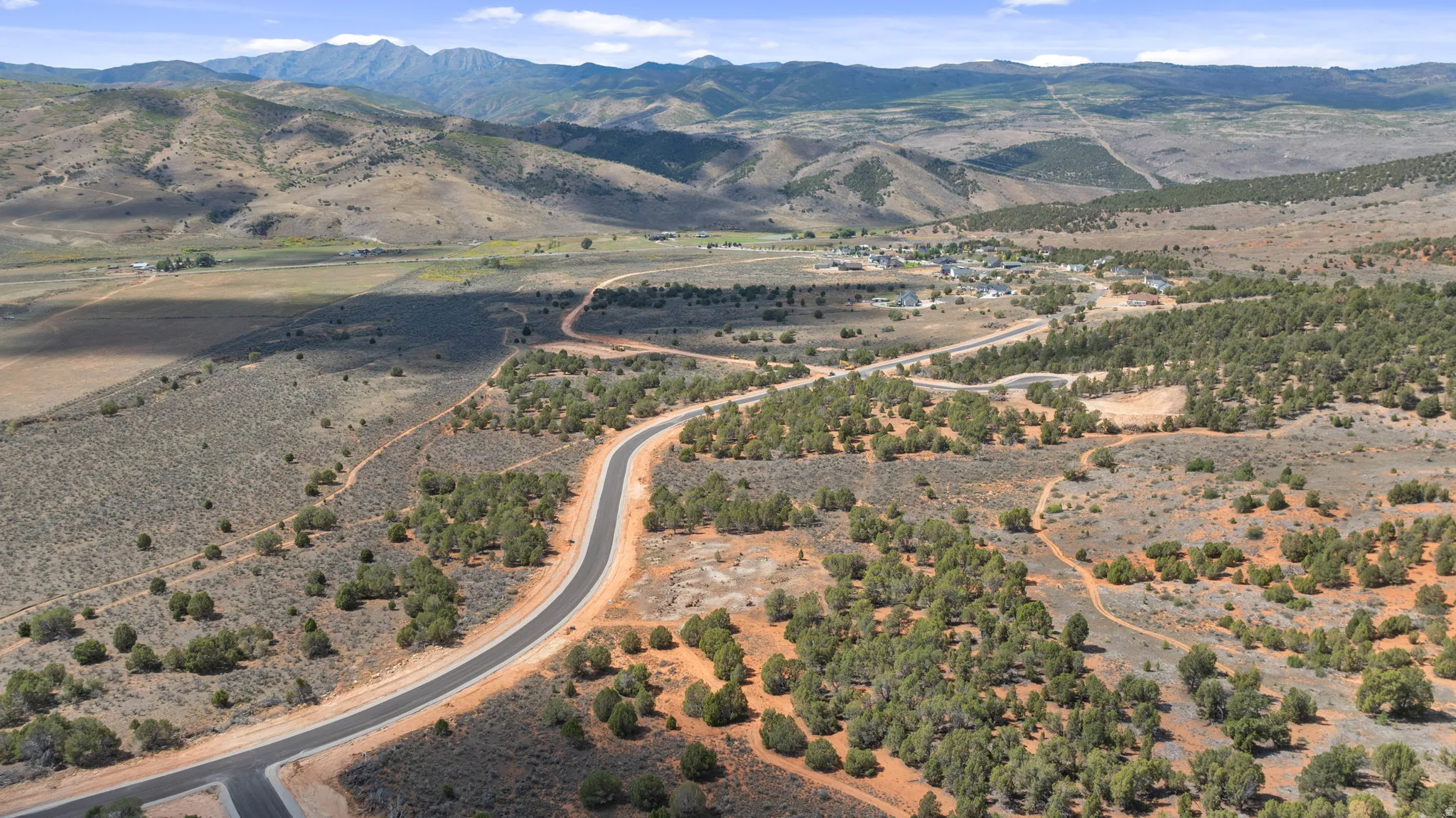 Paved road winding through a landscape of diverse terrain