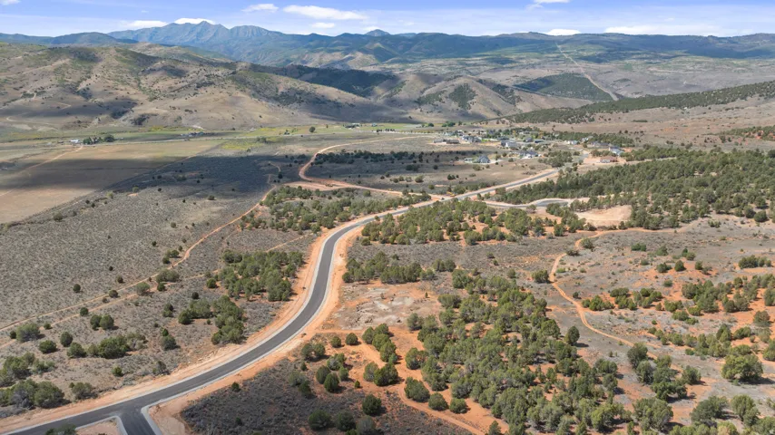 Paved road winding through a landscape of diverse terrain