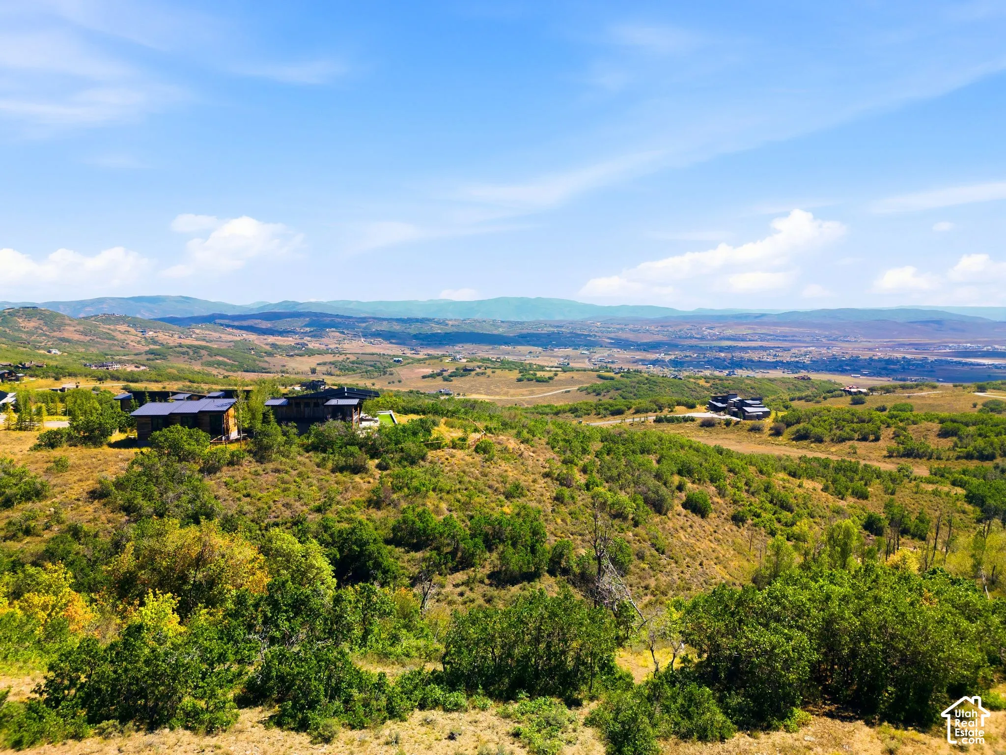 Expansive elevated terrain featuring natural landscaping and distant mountain ranges