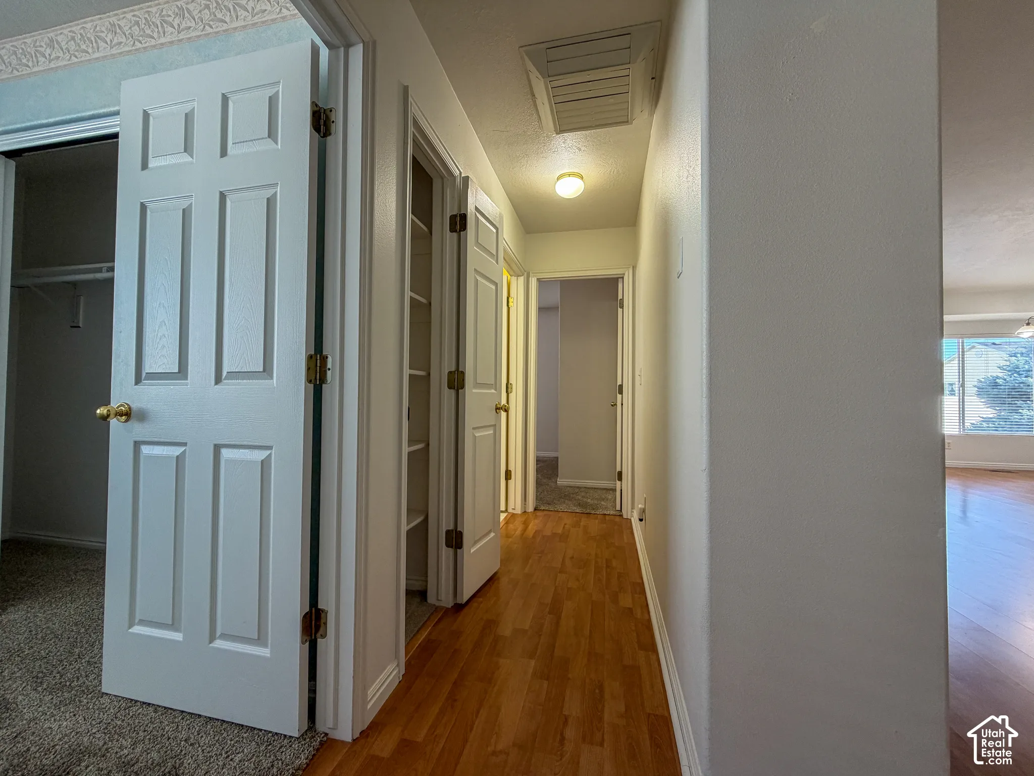 Wood-finish flooring throughout the hallway