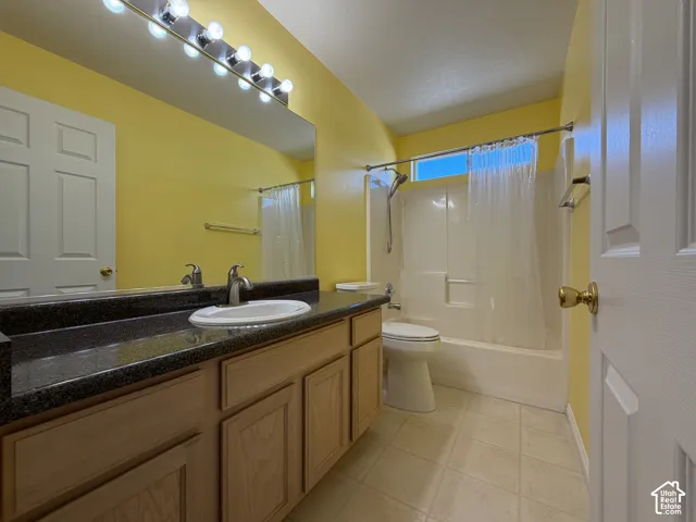 Single vanity with an integrated sink, brushed nickel faucet, and a dark speckled countertop