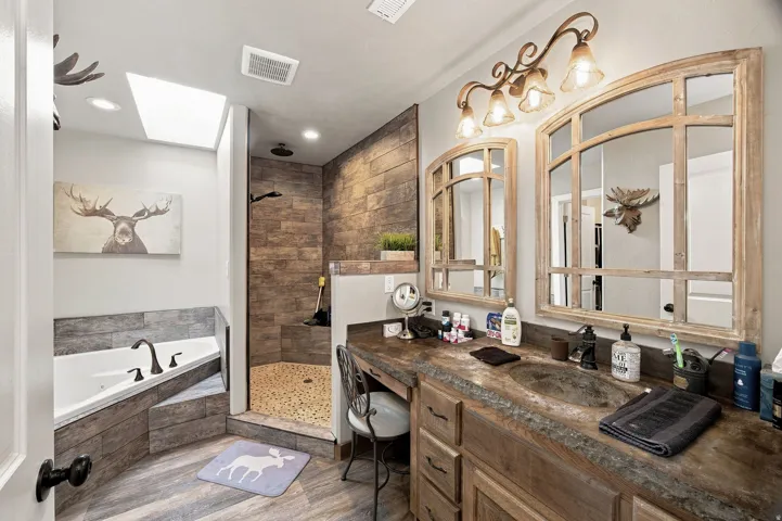 Dual vanity with integrated sinks, distressed wood-finish cabinetry, and a textured countertop