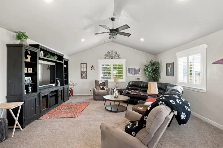 Vaulted ceiling with recessed lighting and a ceiling fan